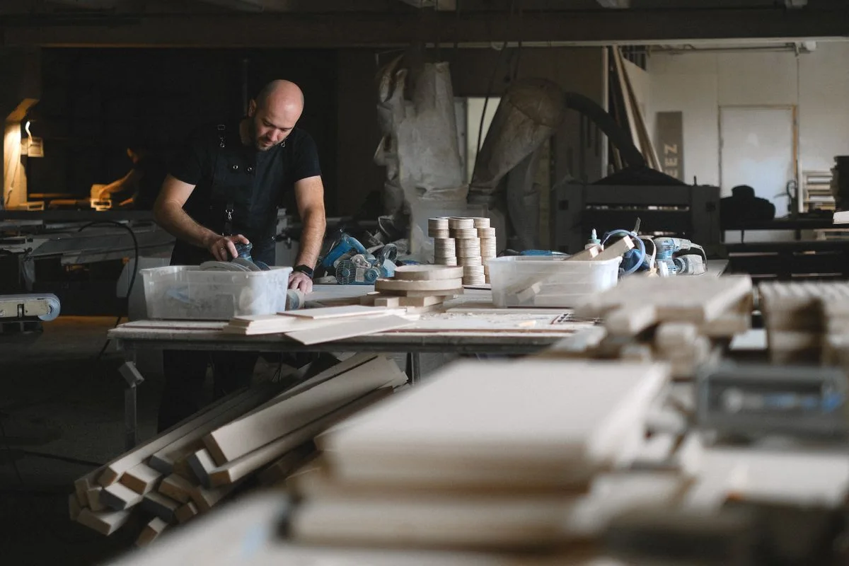 Woodworker crafting furniture; illustrative custom-furniture photograph