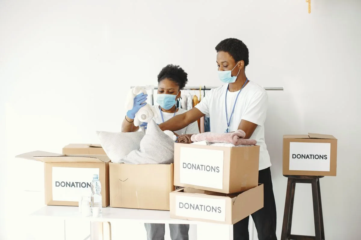 Volunteers packing donations; illustrative community-nonprofit photograph