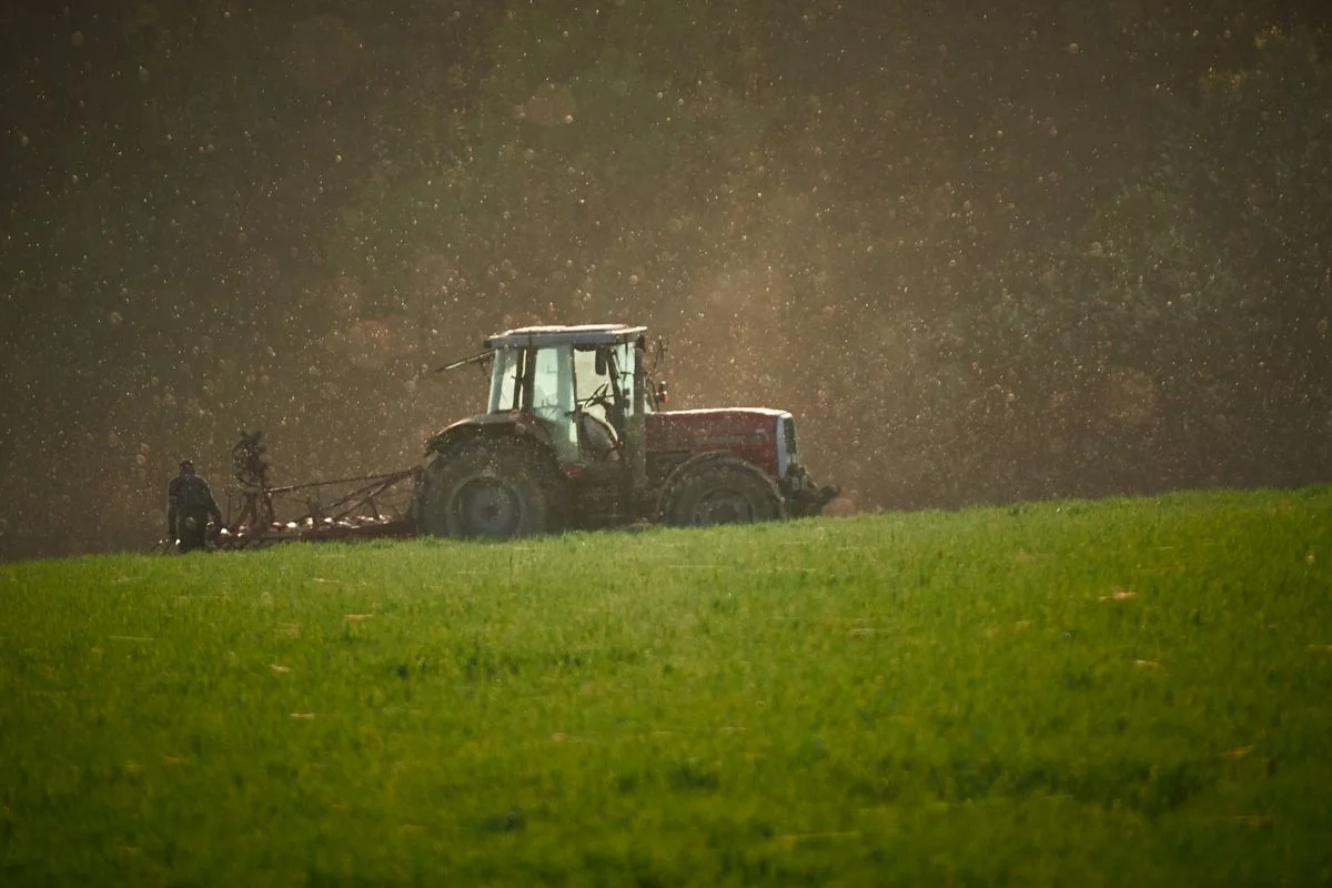 Agricultural tractor at work; illustrative equipment-sales photograph