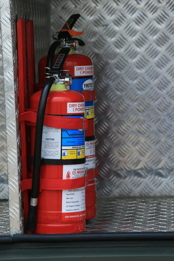 Fire extinguishers in a storage compartment; illustrative safety-equipment photograph