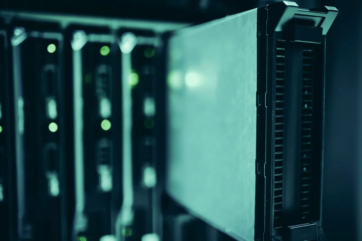 Server racks and network infrastructure; illustrative IT-services photograph